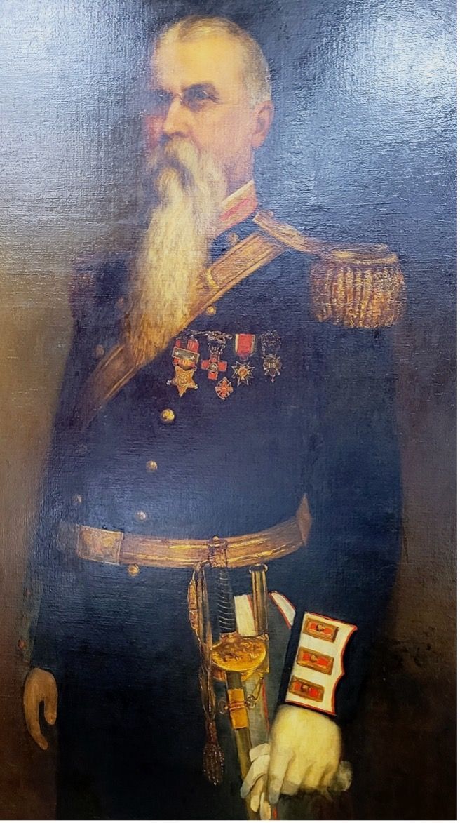 Portrait of a uniformed man with a long white beard, medals, and a saber; likely a military officer.