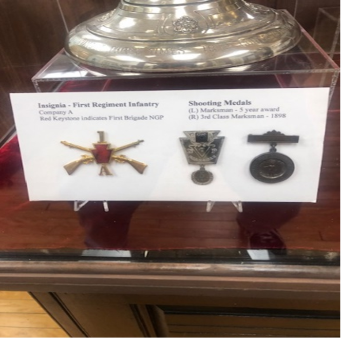 Display of military insignia and shooting medals, 