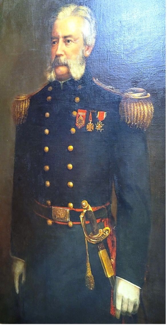 Portrait of a distinguished man in a navy blue uniform, gold epaulets, and medals; gray mustache.