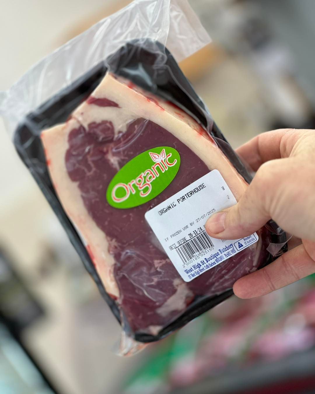Hand Holding A Vacuum-sealed Package Of Organic Steak — West High Street Boutique Butchery In Coffs Harbour, NSW