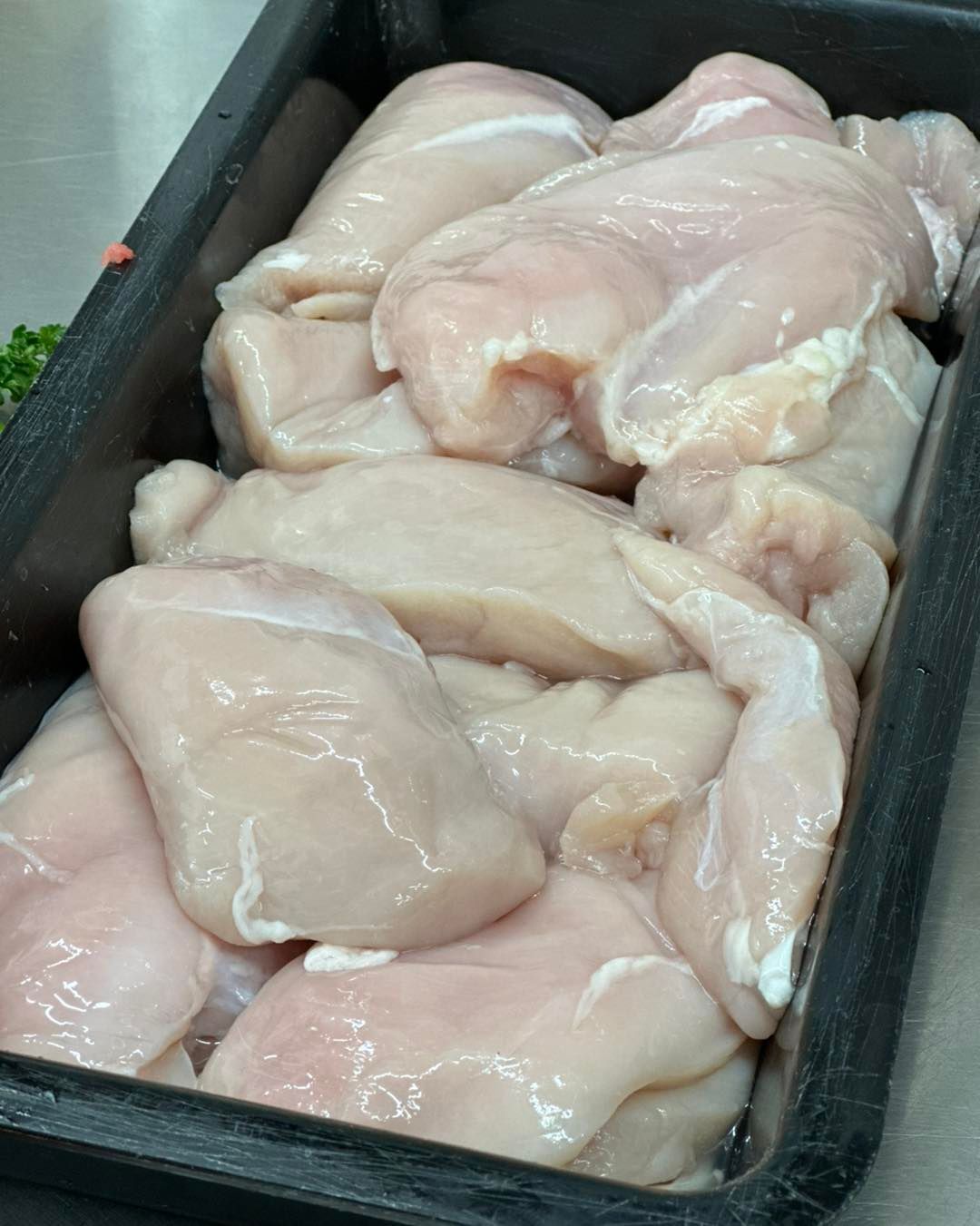 Raw chicken breasts in a black tray, close-up shot — West High Street Boutique Butchery In Coffs Harbour, NSW