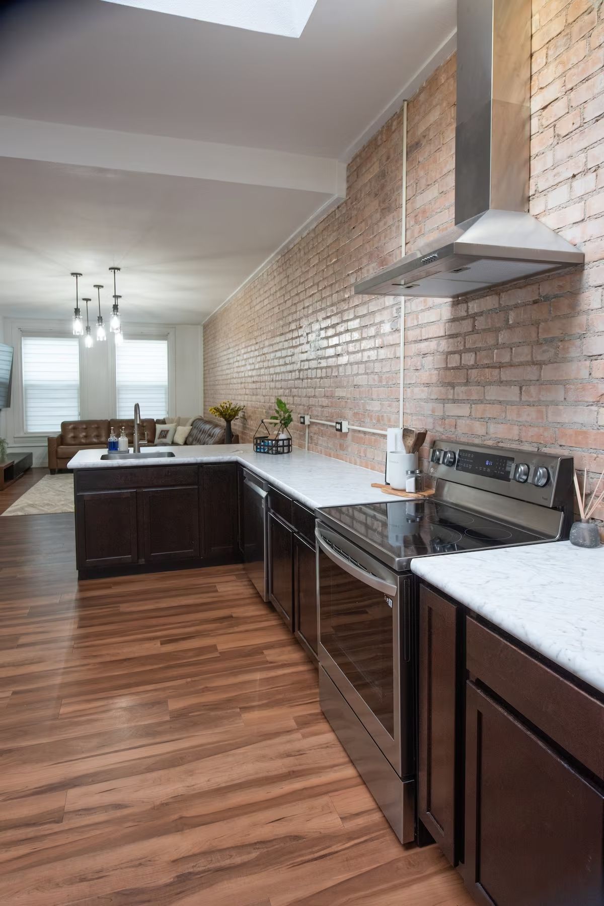 Photo showing a living room and kitchen with an open floor plan, and updated features