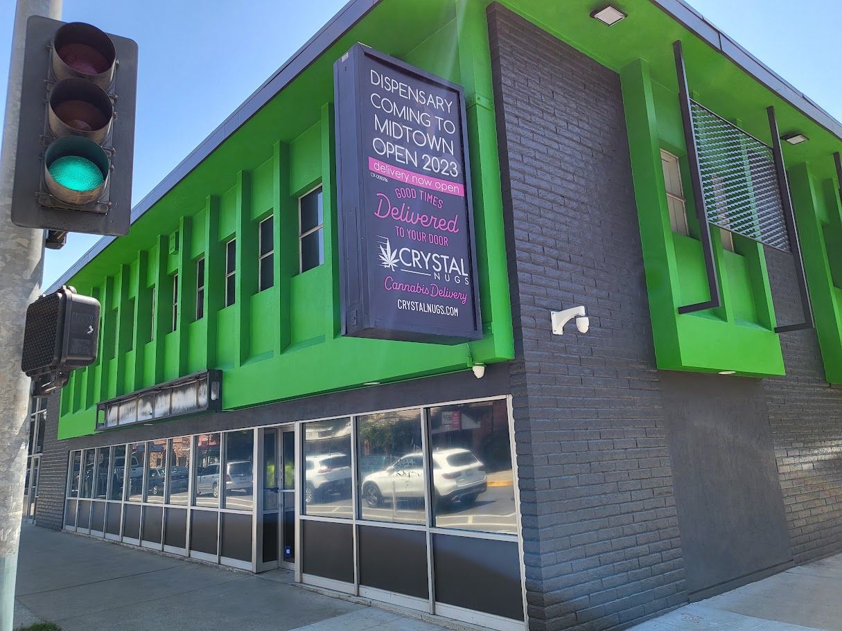 Green and gray building with a sign that says 