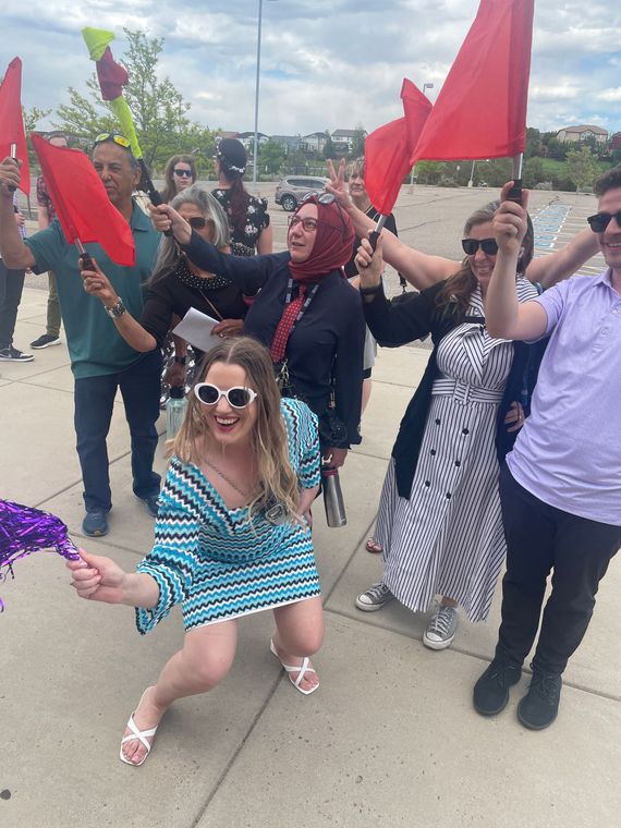 A group of people are holding red flags in their hands