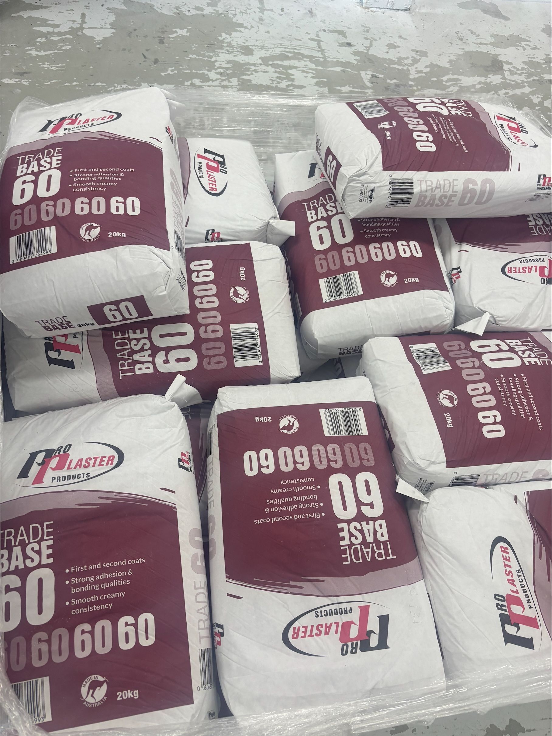 A Person is Applying Adhesive to a Wall With a Trowel — North Coast Plaster Solutions in Lismore, NSW