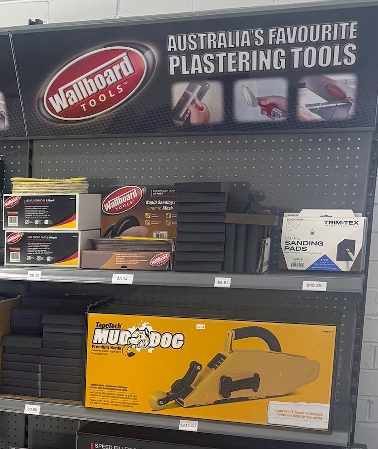 A Man is Using a Drill to Drill a Hole in a Wall — North Coast Plaster Solutions in Lismore, NSW