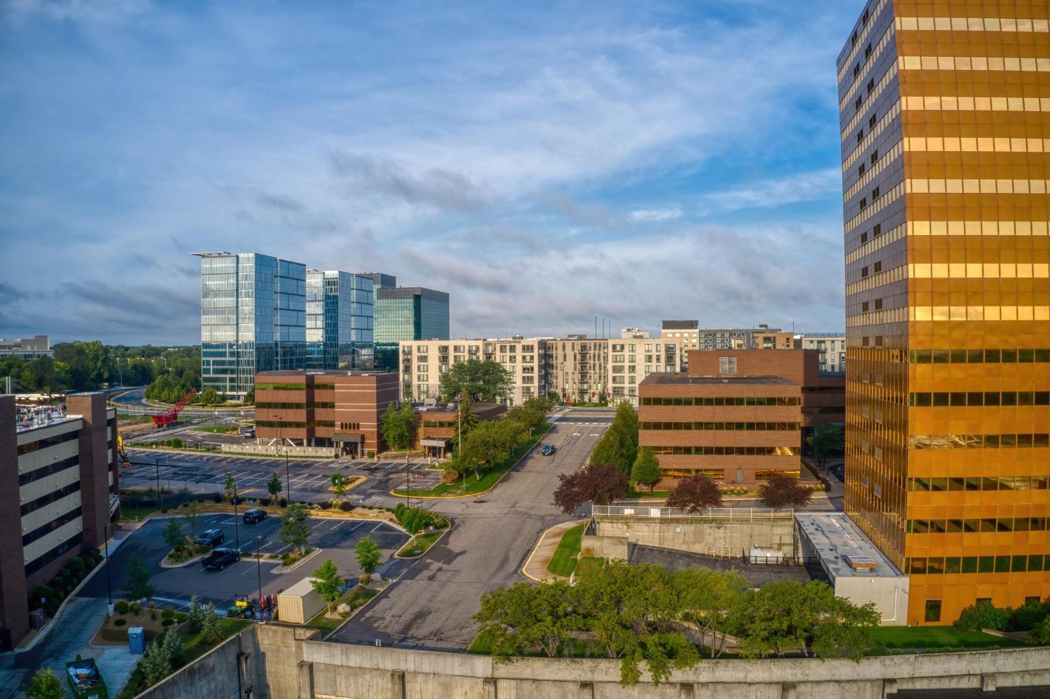 A man with a backpack is standing next to a lake in the woods.