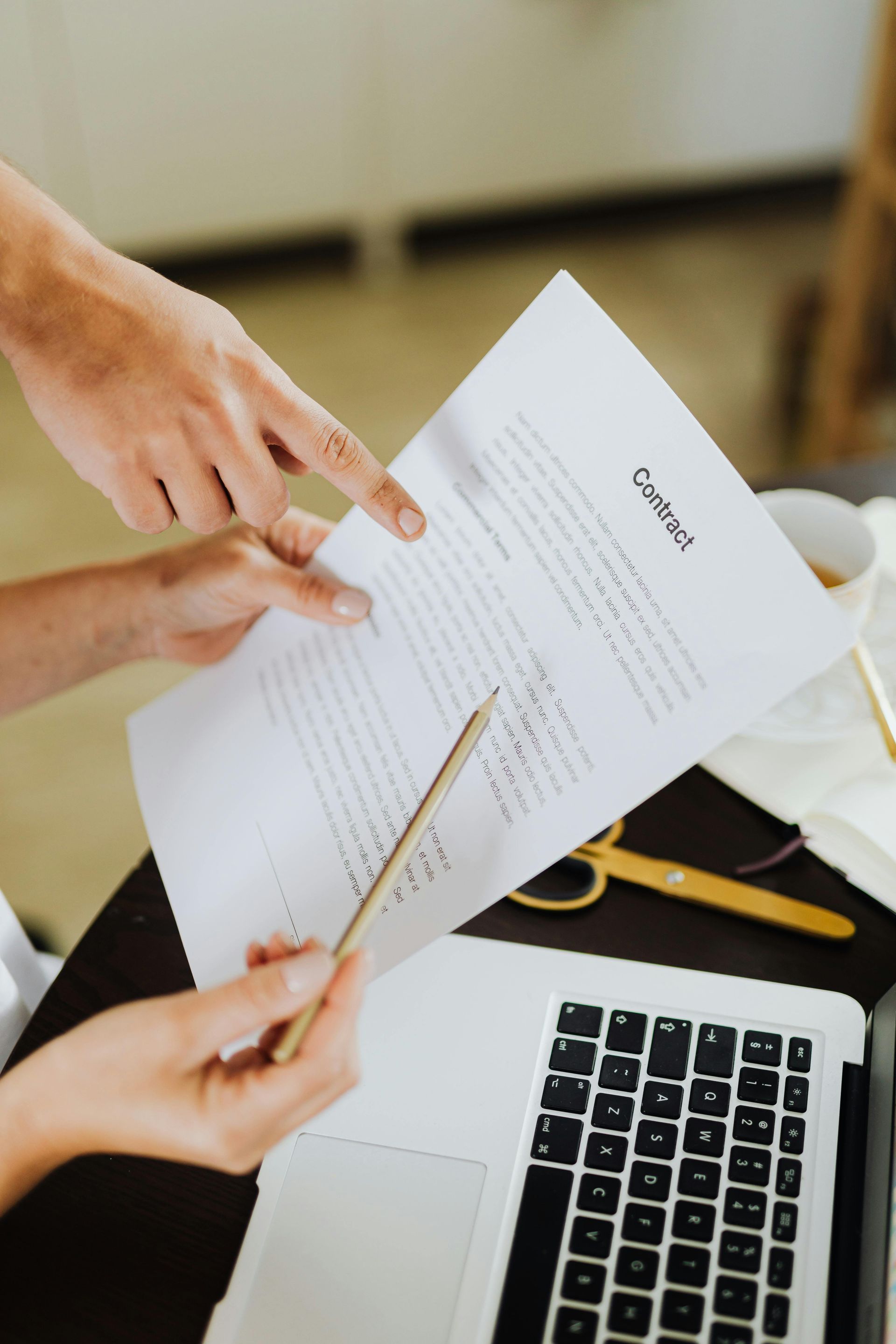 A man with a backpack is standing next to a lake in the woods.