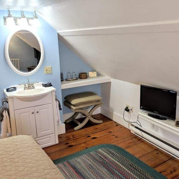 A bathroom with a sink and a flat screen tv