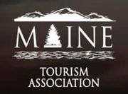 A maine tourism association logo with mountains and trees