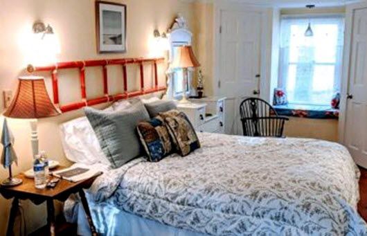 A bedroom with a bed and a ladder headboard