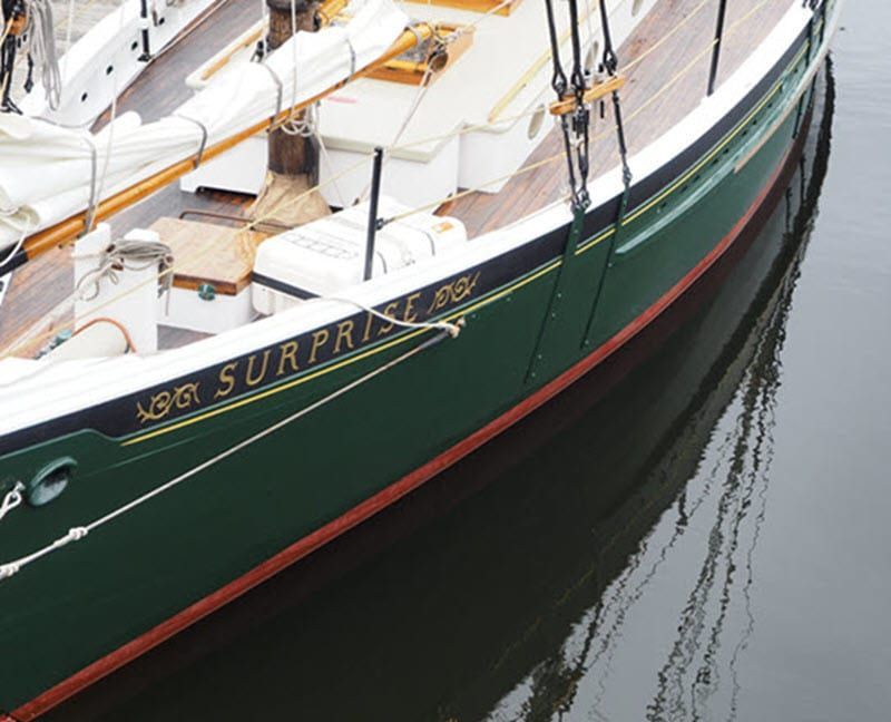 The name surprise is on the side of a boat