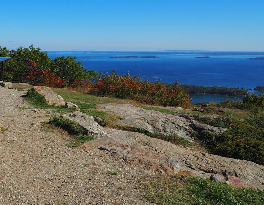 A view of the ocean from a rocky hillside.