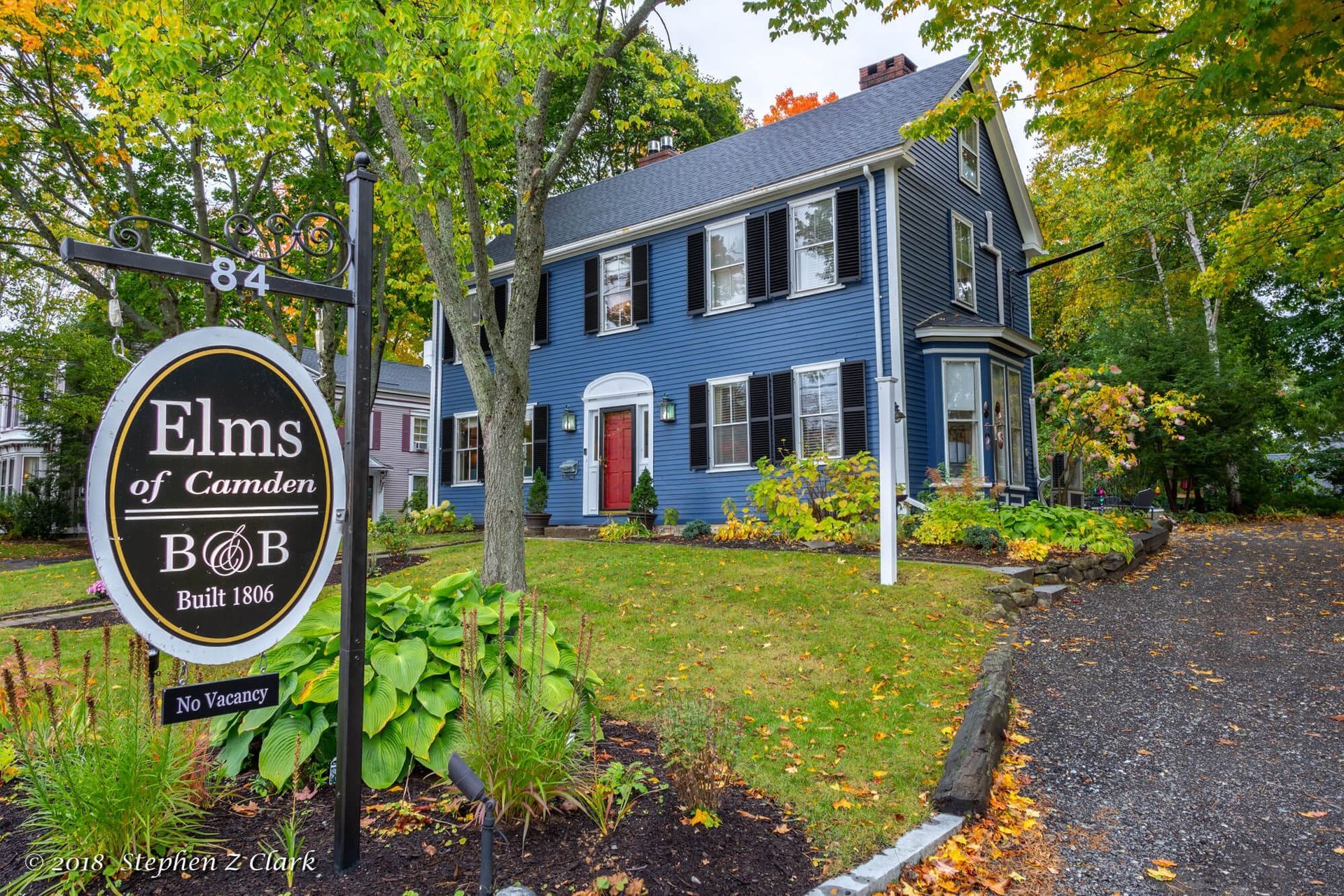 A blue house with a sign in front of it that says elms of camden