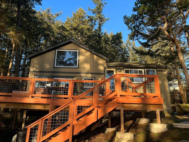 Bathroom with black herringbone floor and wooden vanity