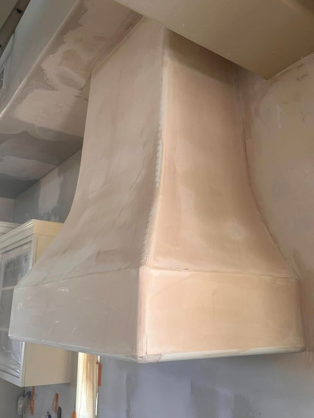 Dining area with modern table and concrete accent wall