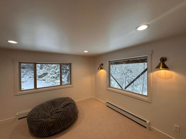 Cabin exterior with deck and stairs surrounded by trees