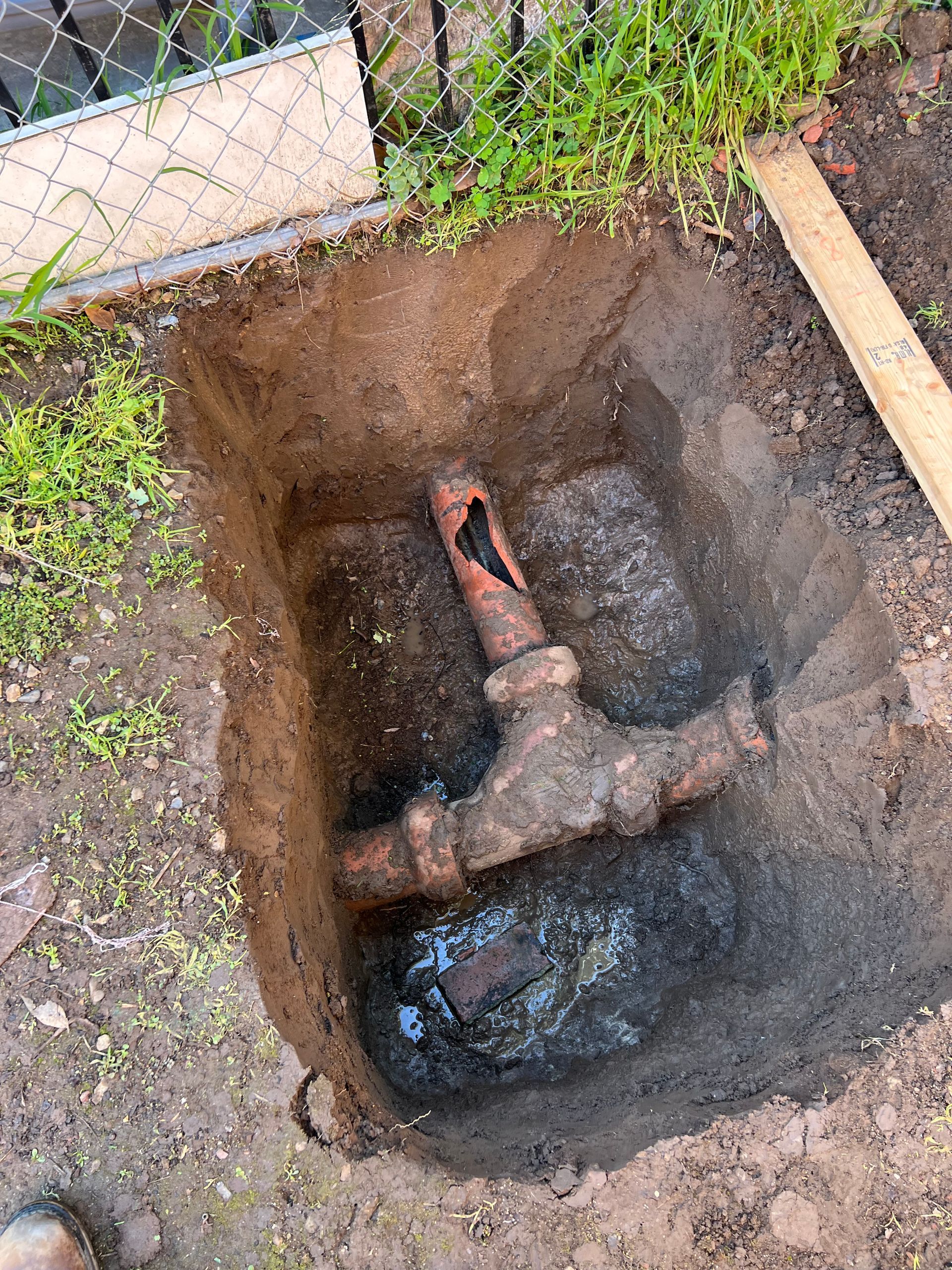 A Drain Pipe Is Sitting In A Hole In The Ground - Oxnard, CA – 4J's Plumbing And Drain Cleaning