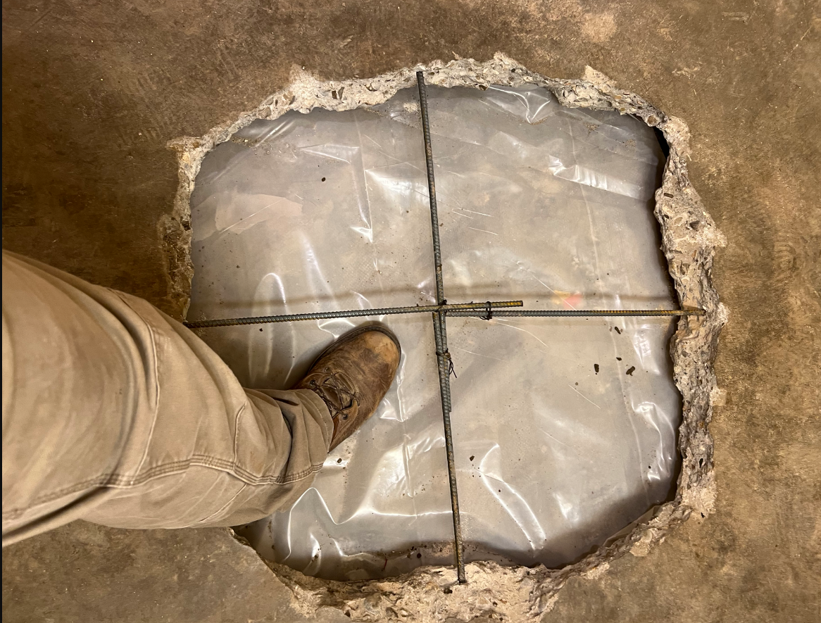 A Person Is Standing In A Hole In The Floor - Oxnard, CA – 4J's Plumbing And Drain Cleaning