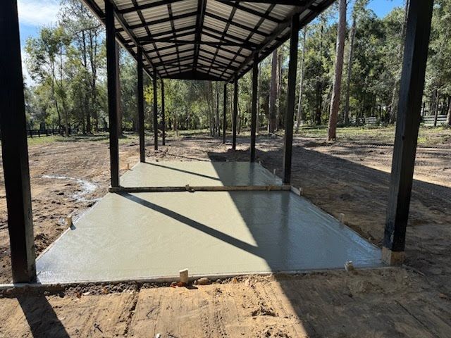 Laying cement pavement on a walkway with a rubber hammer and gloves on a sand. House improvement
