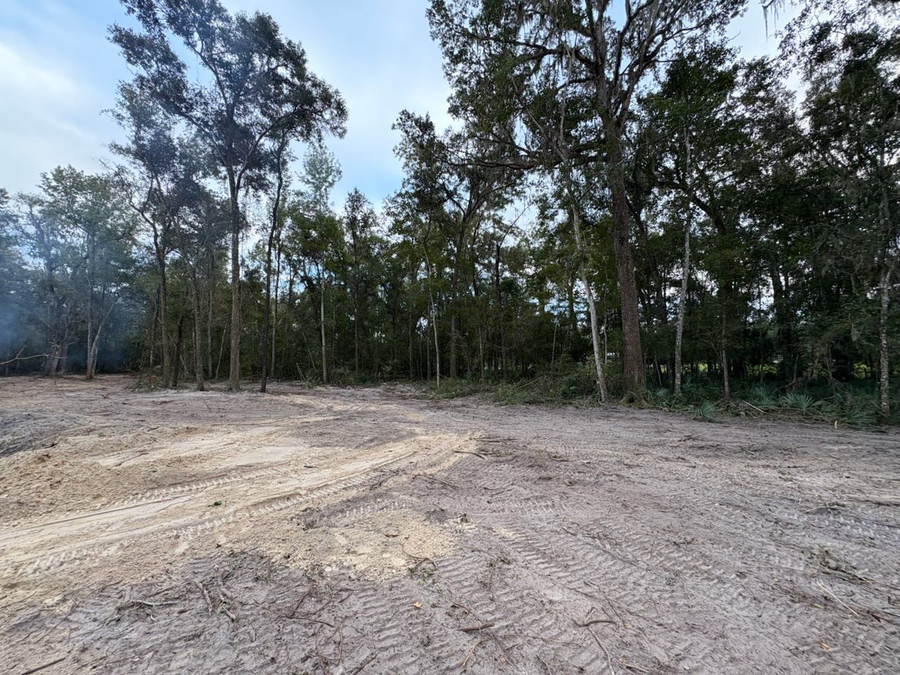 Grader clearing and leveling of the soil to install concrete slabs