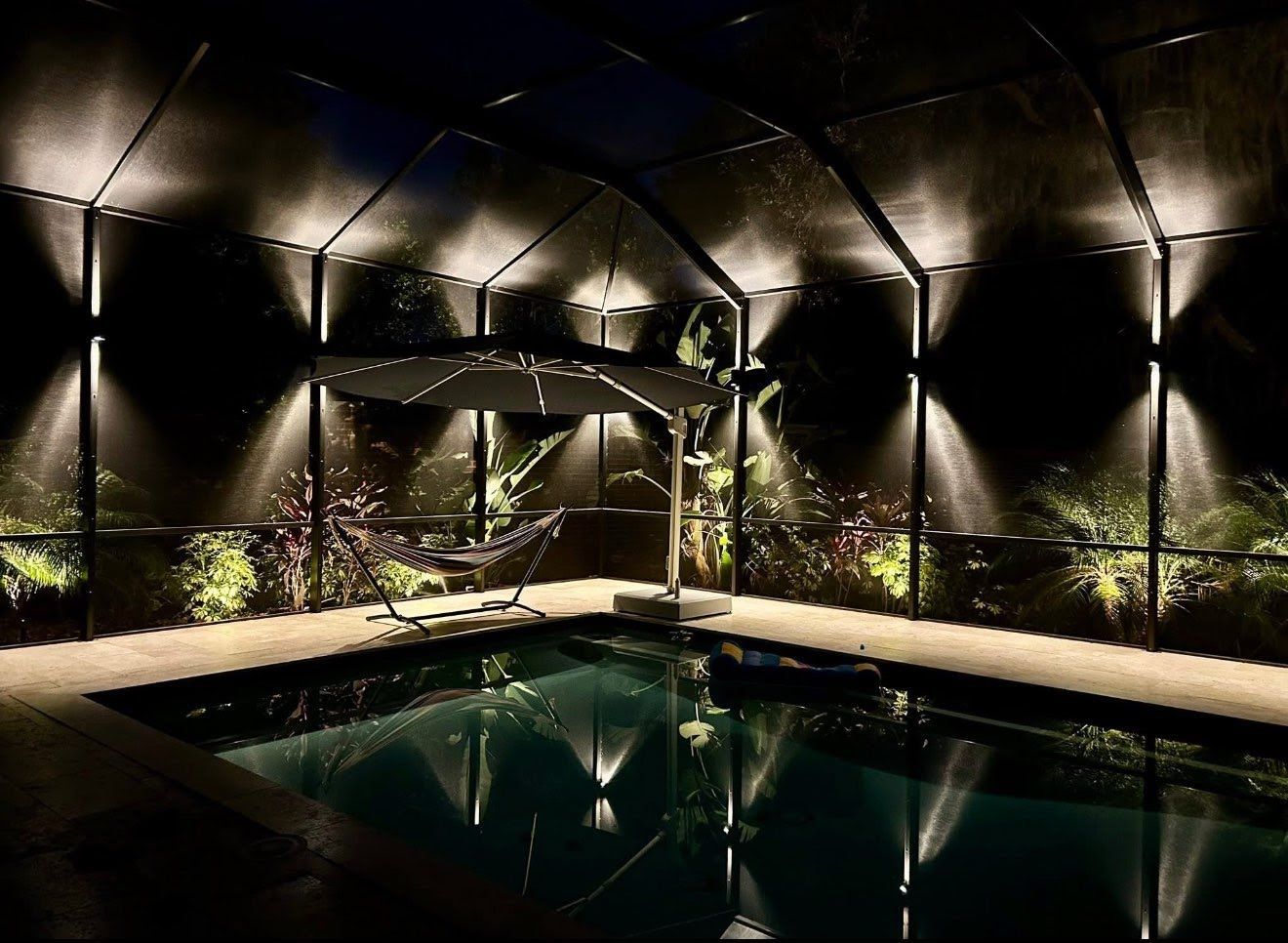 Home garden at night, illuminated by globe shaped lights