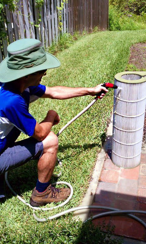 Man Cleaning Filter — Gainesville, FL — Florida Leisure Pool & Spa