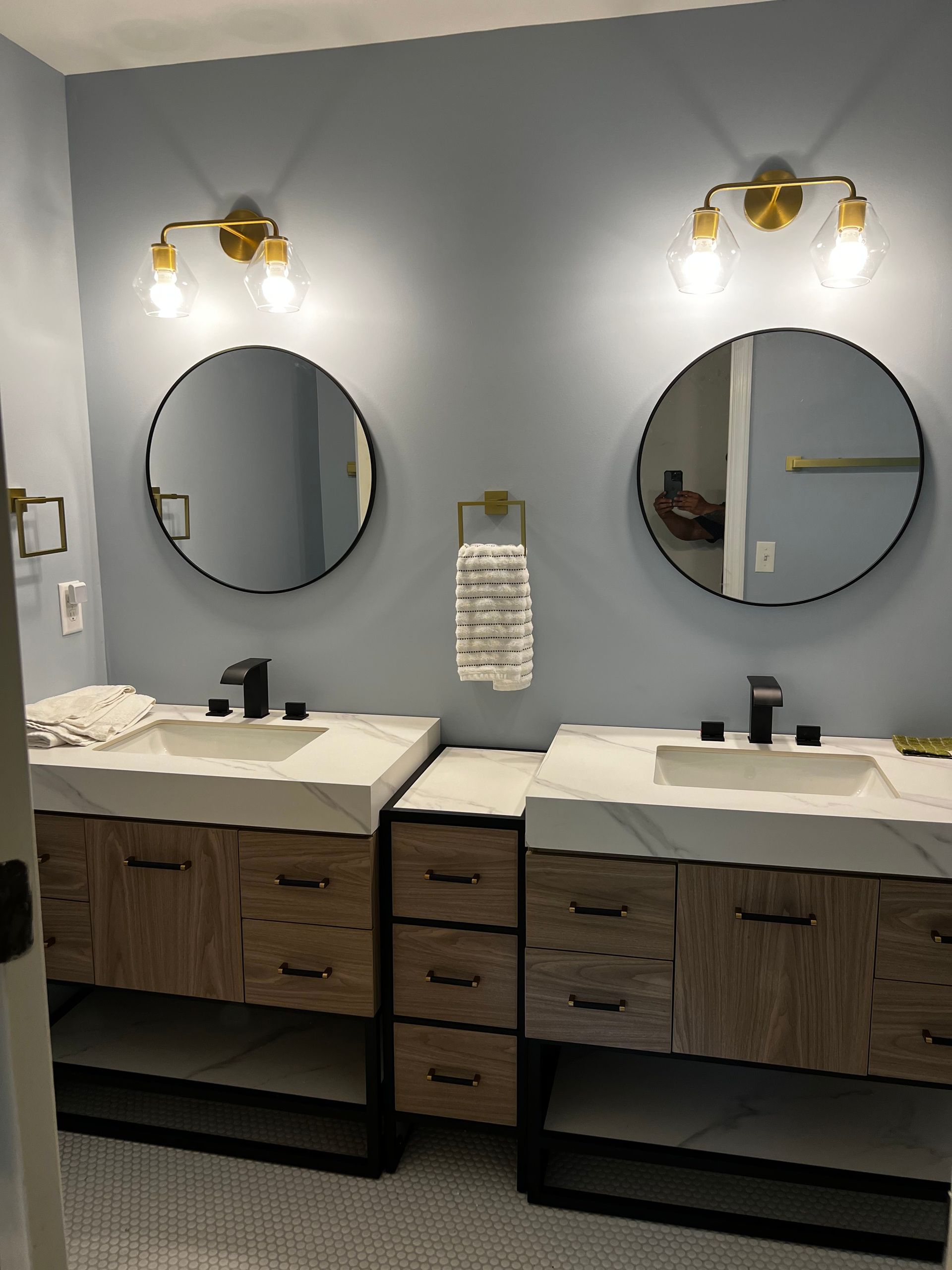 A bathroom with two sinks and two mirrors.