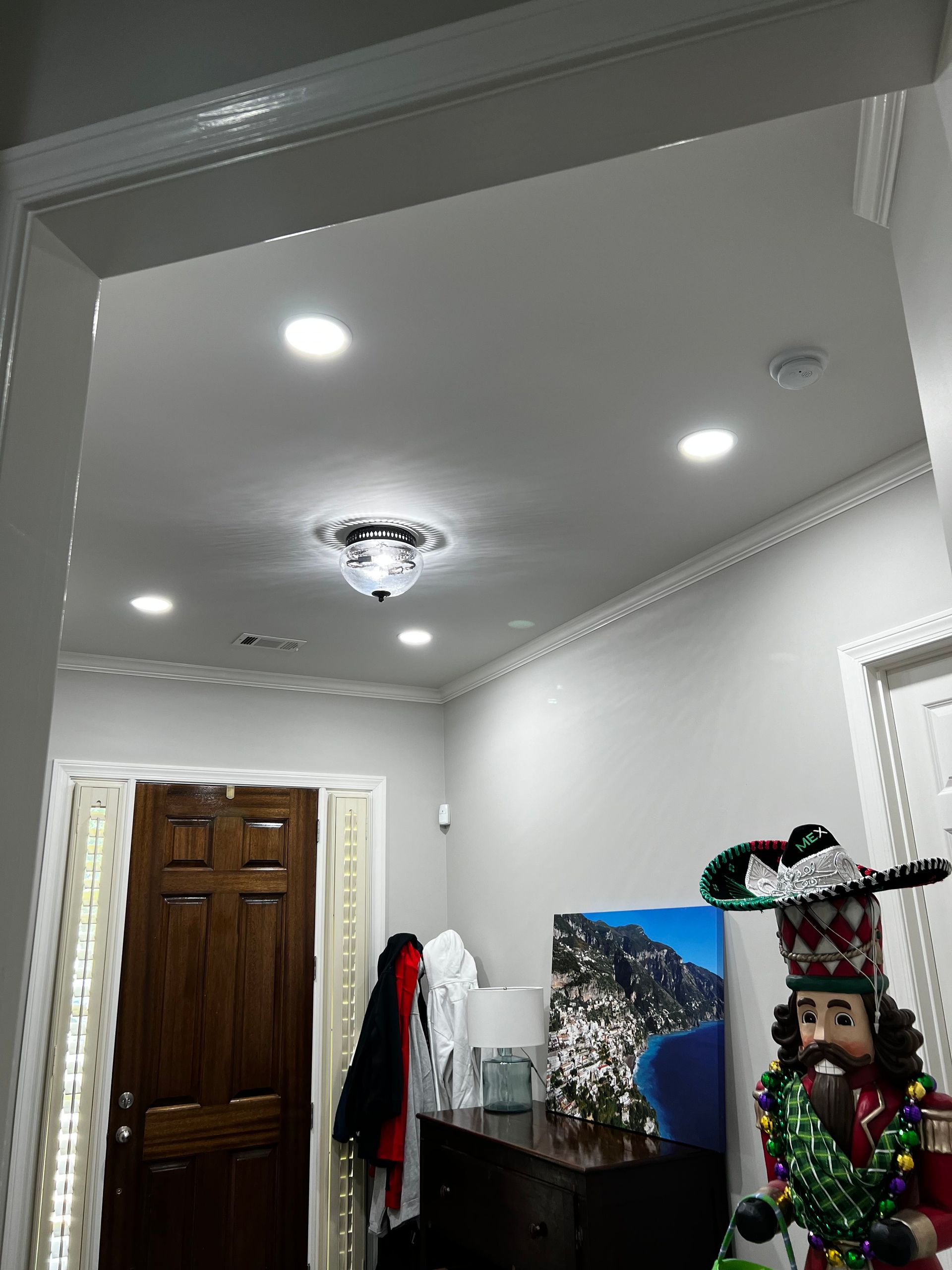 A room with a door and a nutcracker on the wall