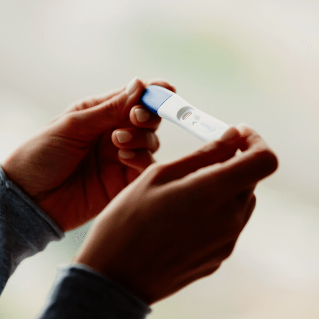 A person holding a pregnancy test paired with text that reads considering abortion.