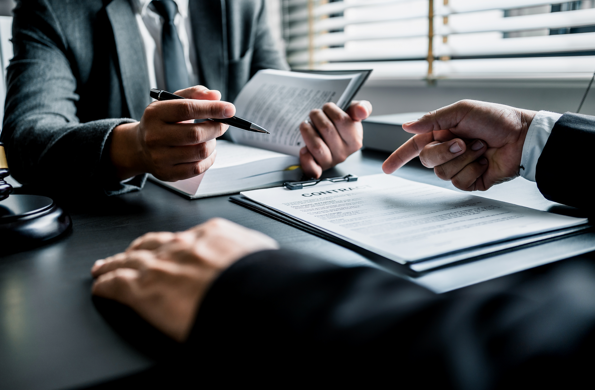 Two men are sitting at a table looking at a piece of paper.