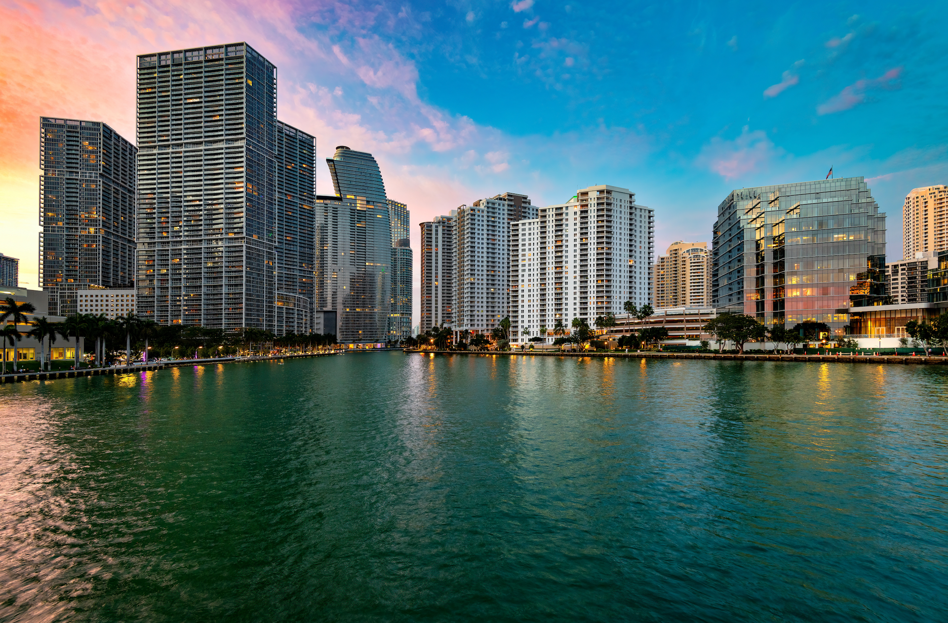 A city skyline with a body of water in the foreground