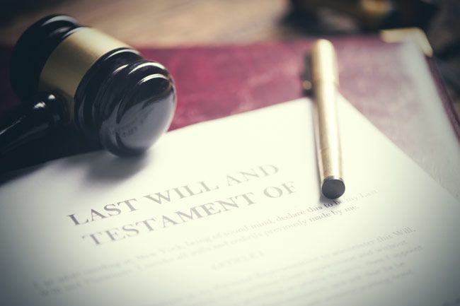 A gavel is sitting on top of a last will and testament.