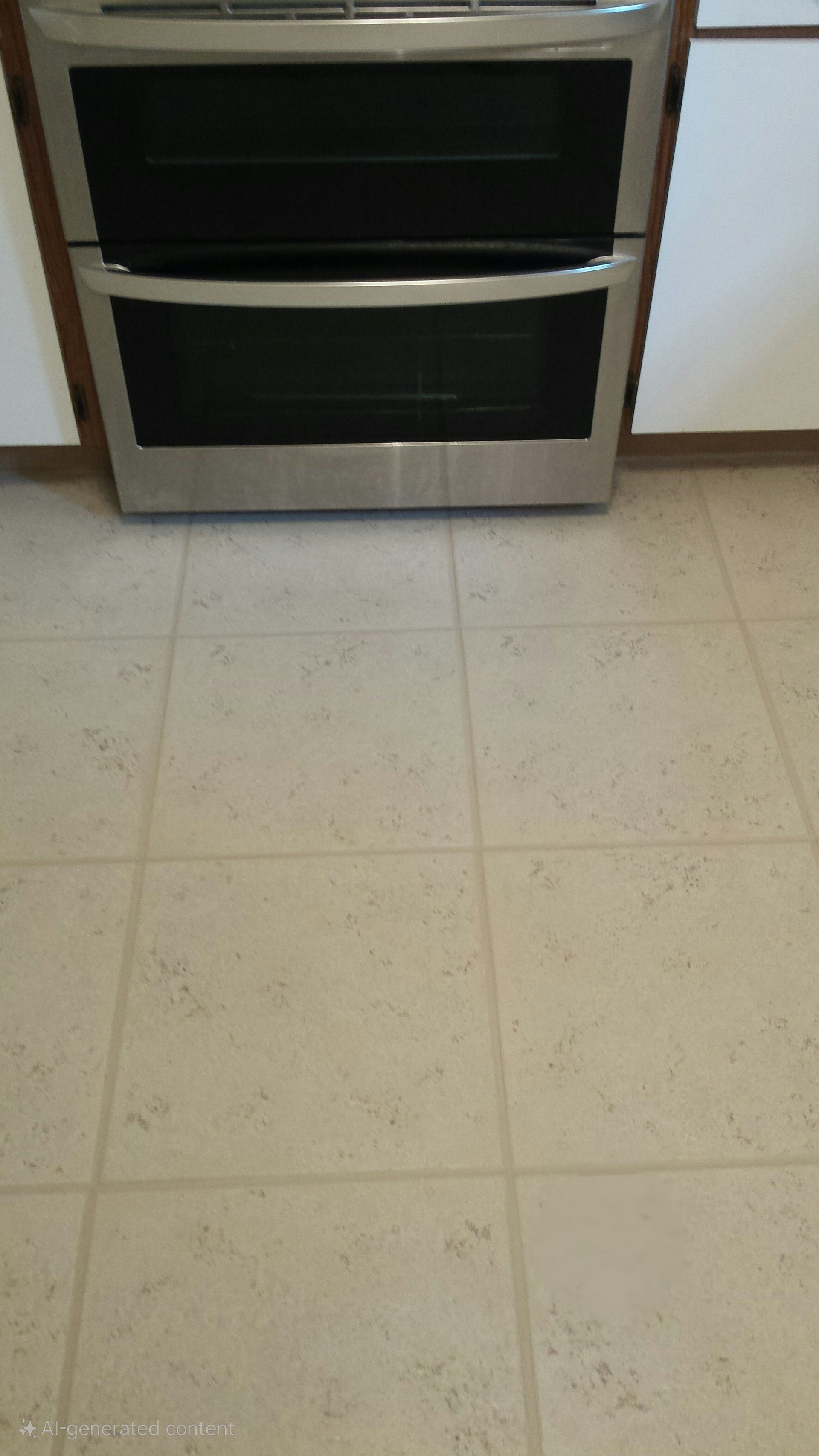 A stainless steel oven is sitting on top of a tiled floor in a kitchen.