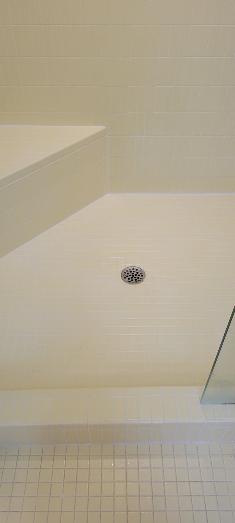 A bathroom with a walk in shower and a sink.