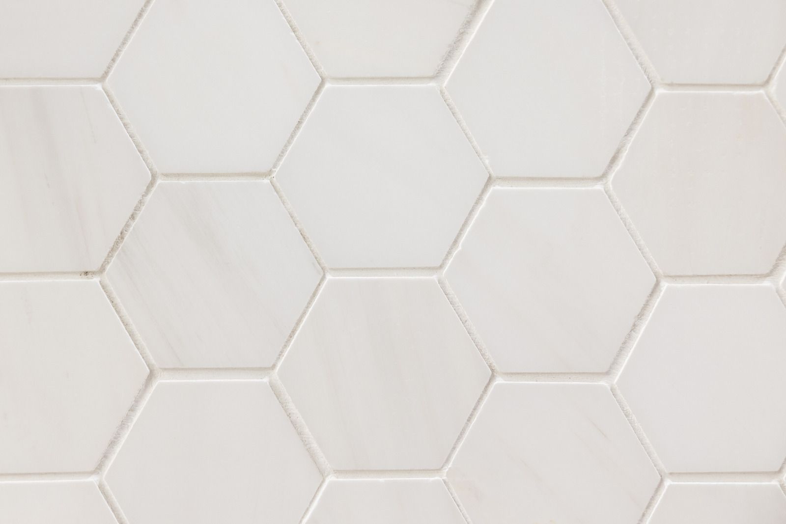 A person is cleaning a tiled floor with a machine.