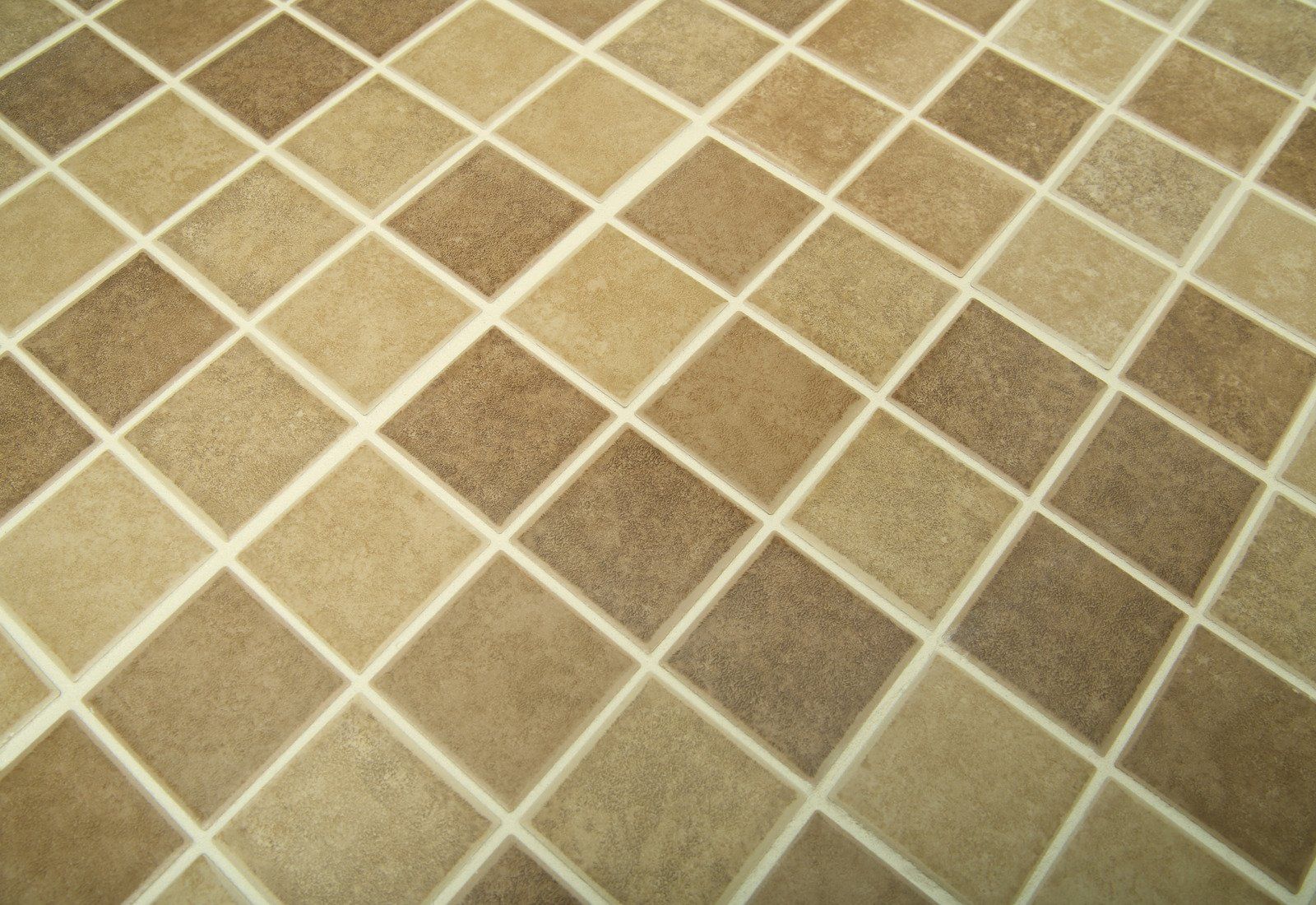 A close up of a tiled floor with a checkered pattern.