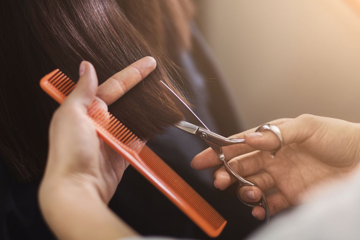 female client receiving a haircut