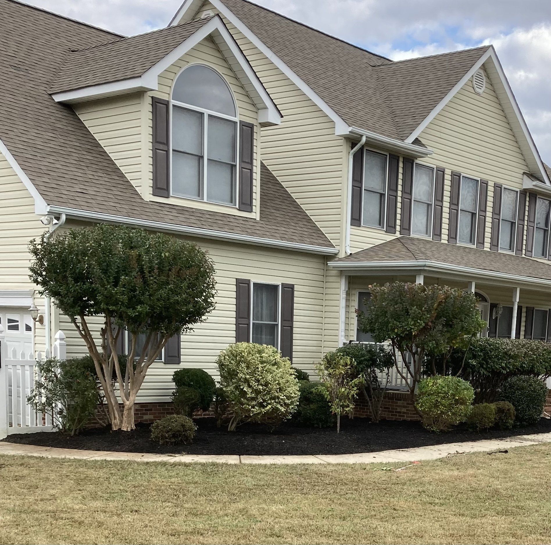 A large house with a lot of windows and trees in front of it