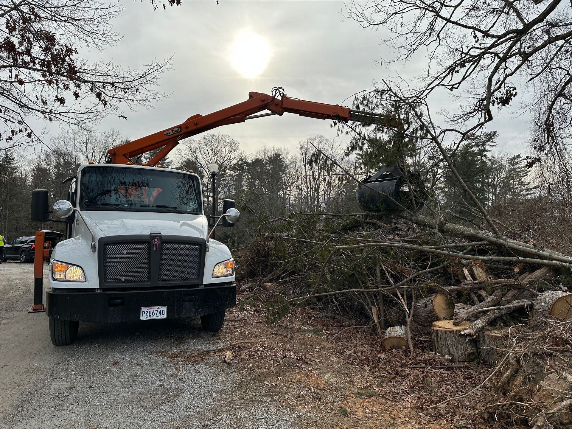 Cruz Disposal’s 28-yard Petersen TL-3 Lightning Loader collecting storm vegetation debris curbside during Hurricane Helene