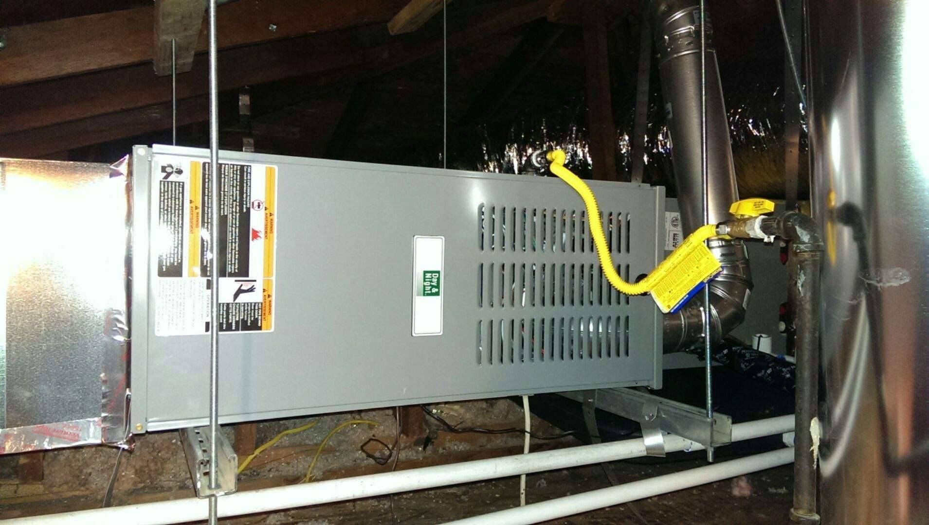 An air conditioner is hanging from the ceiling in a basement.