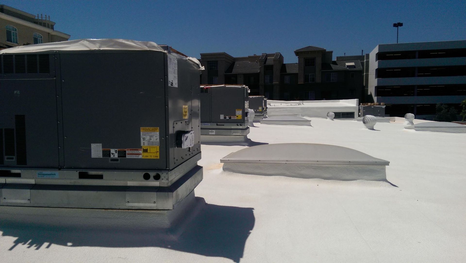 A roof with a lot of air conditioners on it