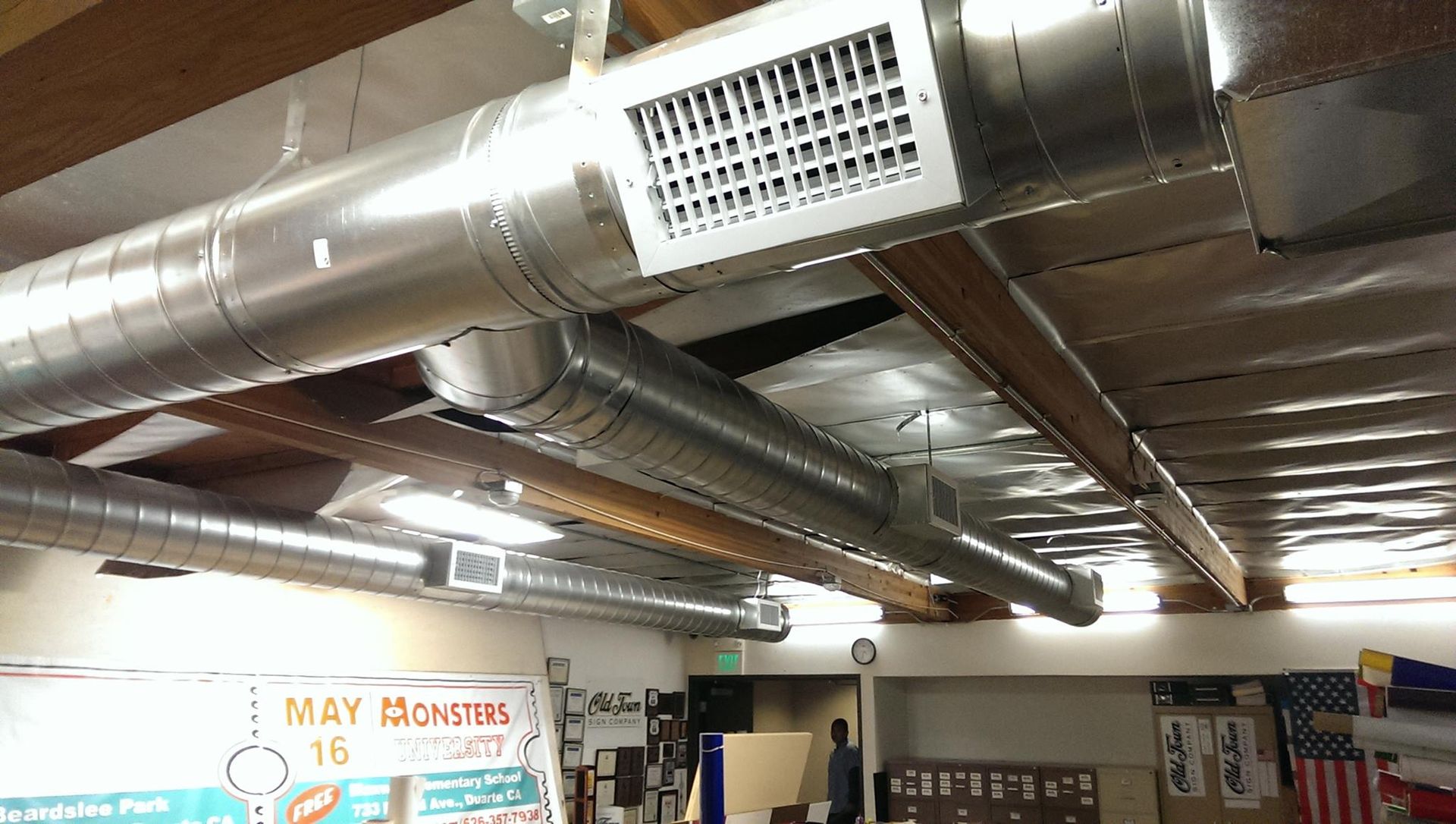 A room with a lot of pipes hanging from the ceiling.