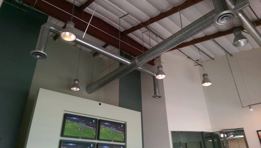 A room with a lot of pipes hanging from the ceiling