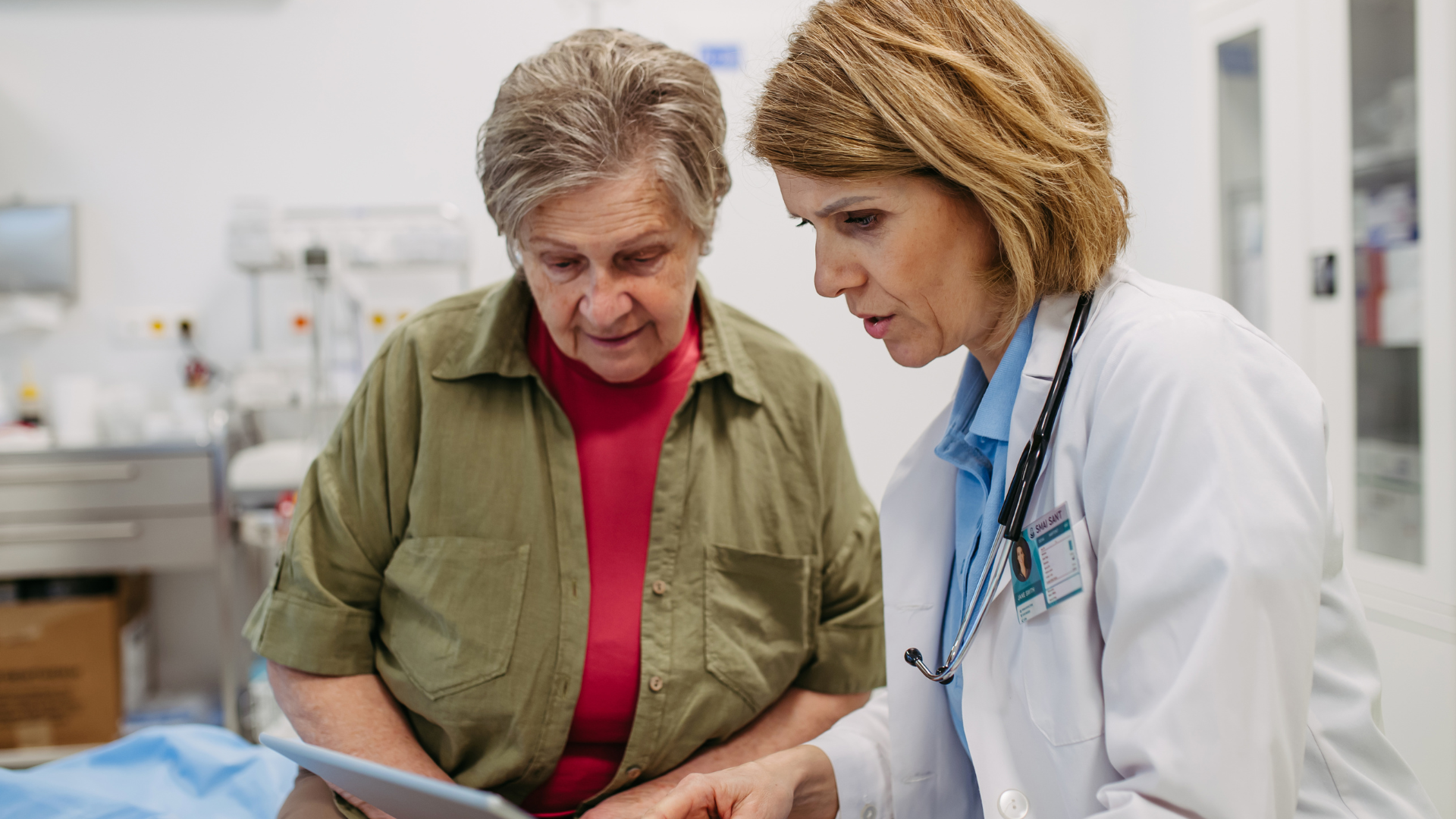 Group of people with hands in a circle, smiling, demonstrating teamwork.