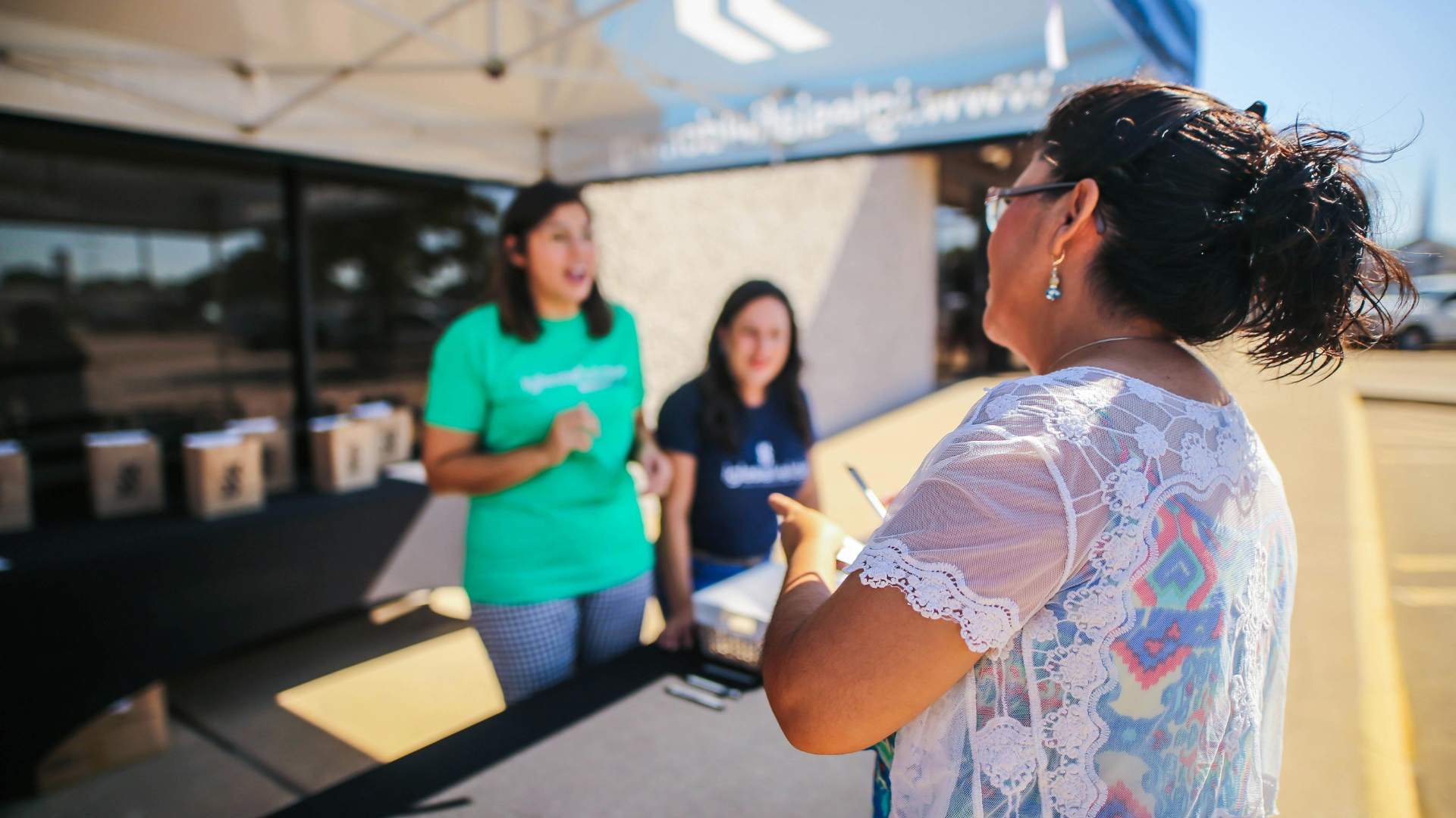 Classroom: Students with diverse backgrounds raise hands, engaged in learning.