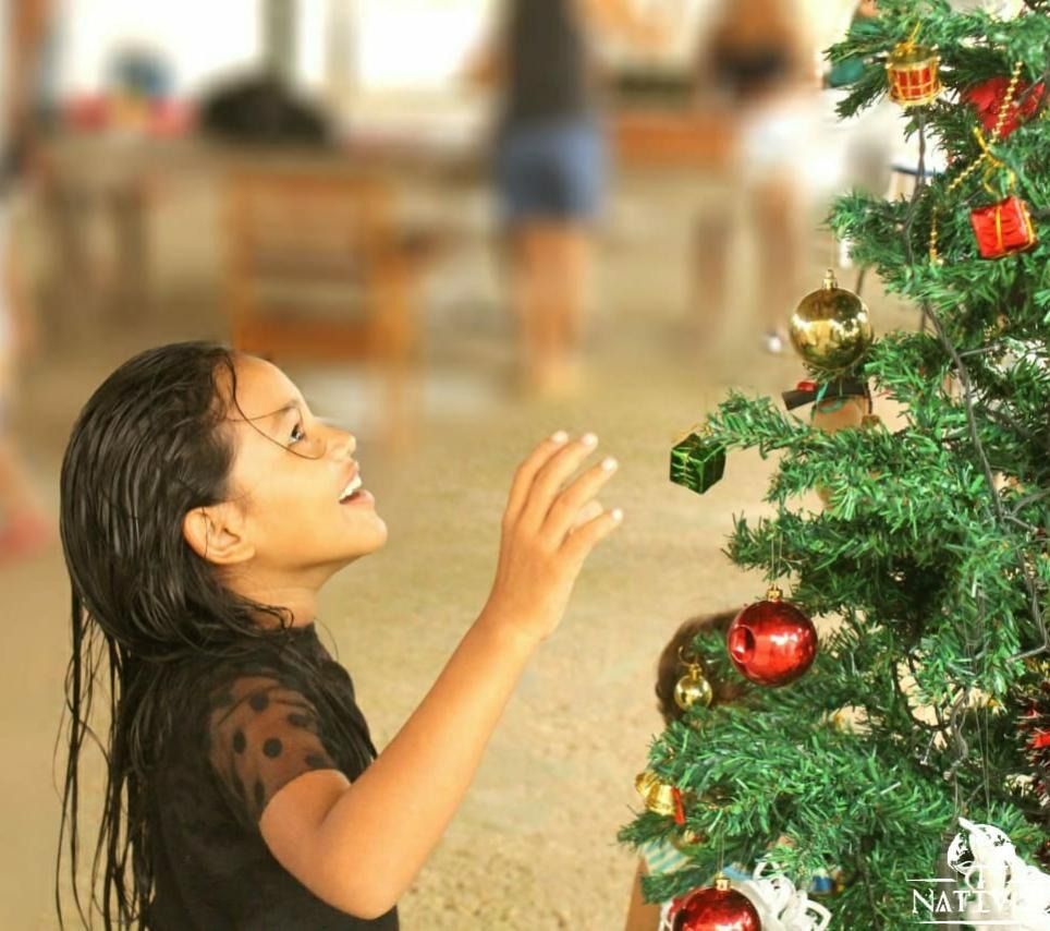 People sorting food items in a food bank, with shelves stocked in the background.