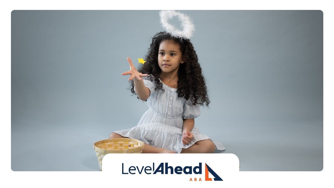 An autistic girl dressed as an angel with a halo, sitting and tossing star-shaped objects in GA.