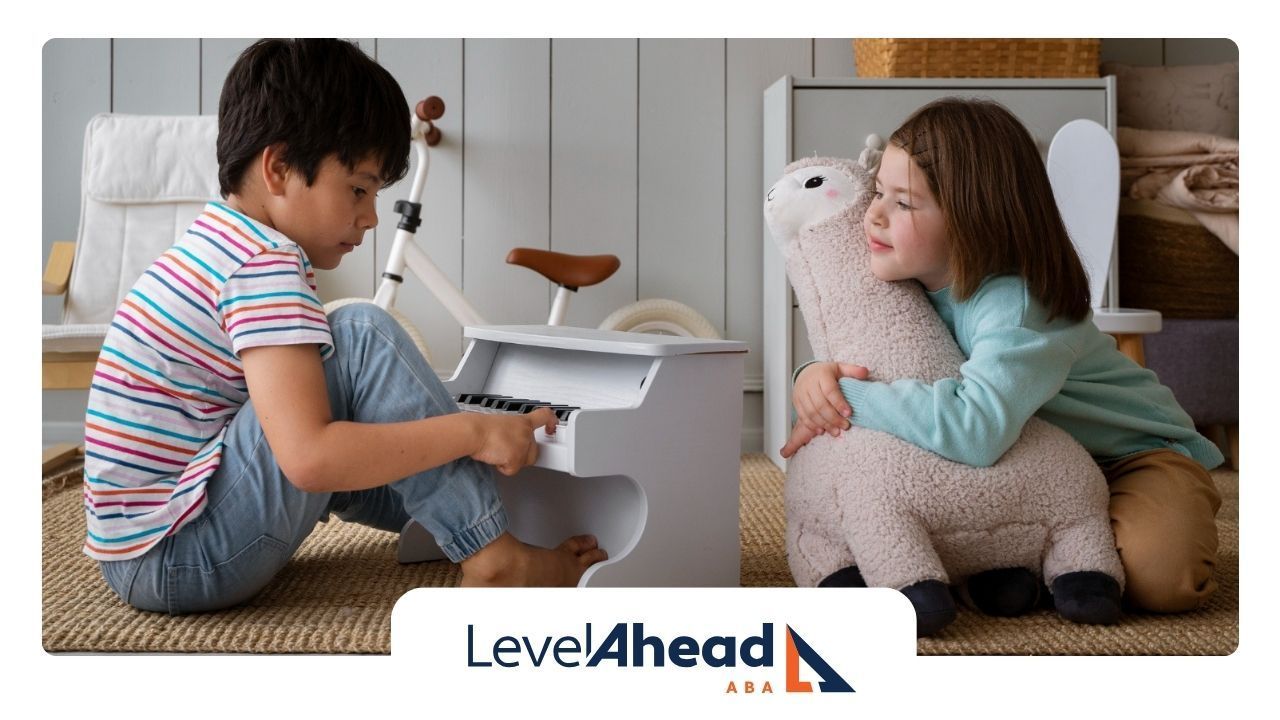 A young boy with autism playing a toy piano while his sister watches.