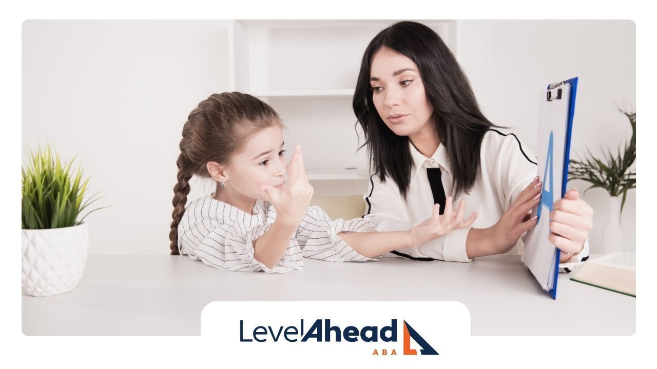 A BCBA is talking to a little girl while holding a clipboard.